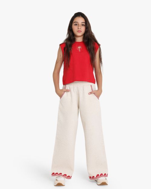 Girls wide-leg beige linen blend pants with red wave embroidery at hem and red stitched pocket detail 4 yrs Front | Locafy